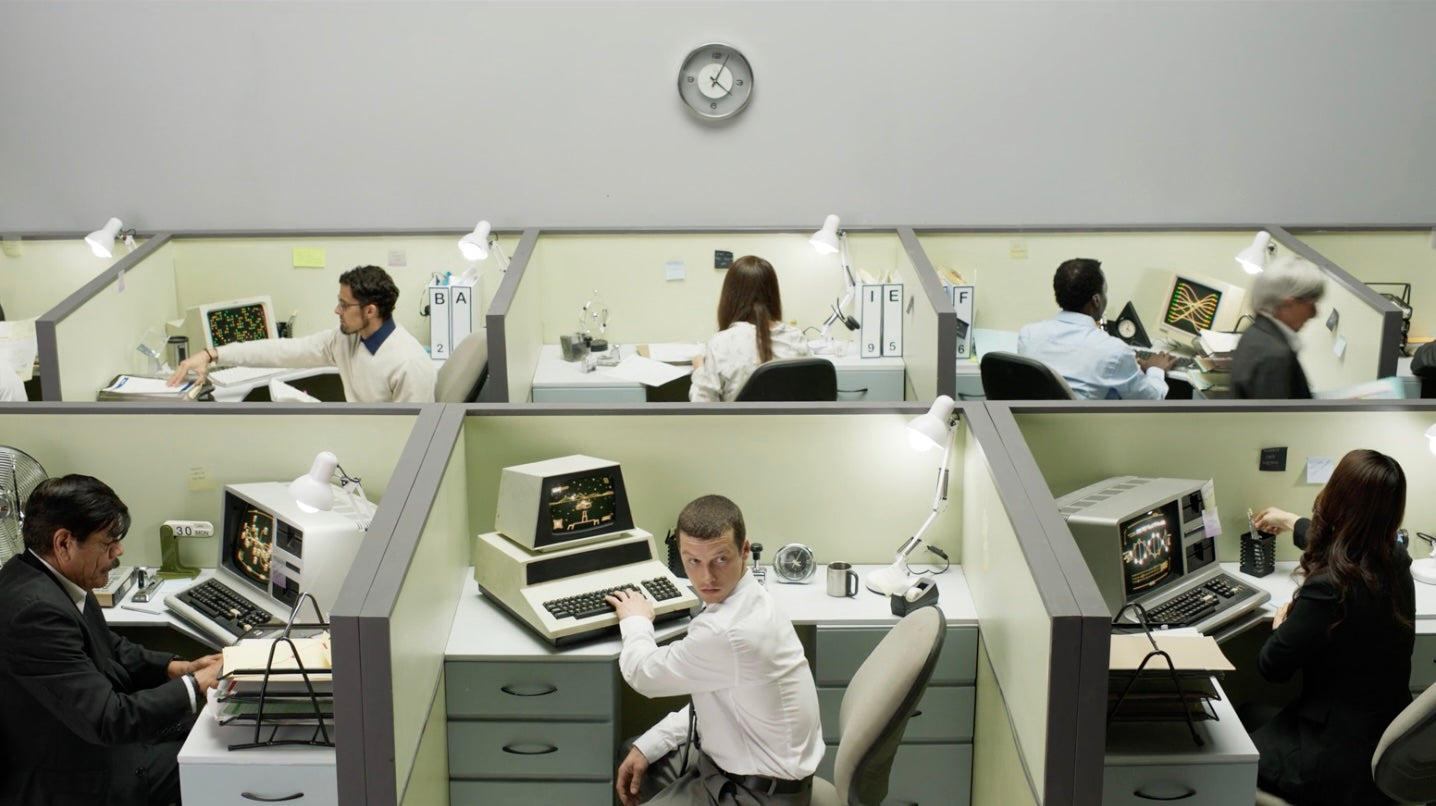 Office with employees working on a retro computers.