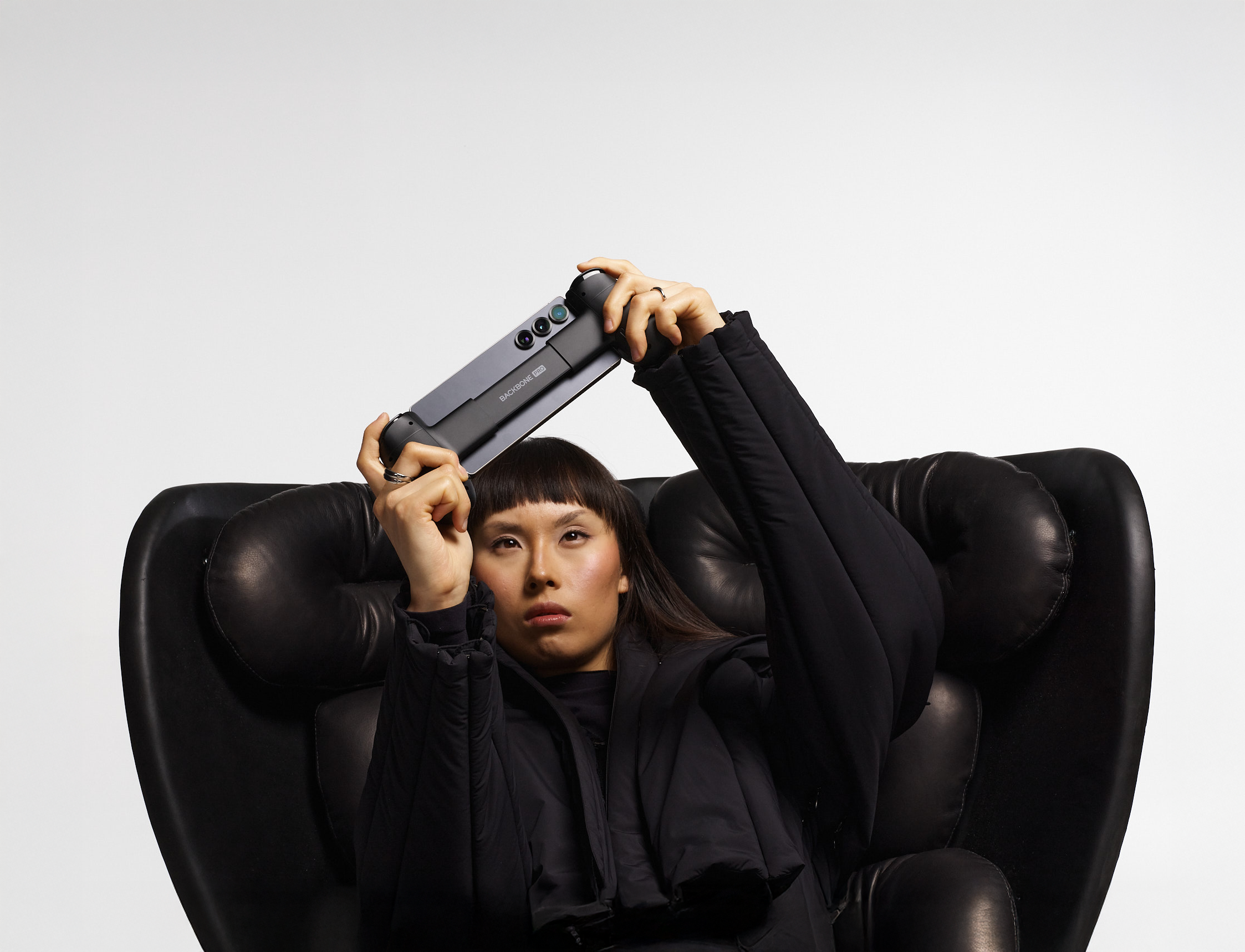 woman with backbone playing games on mobile phone