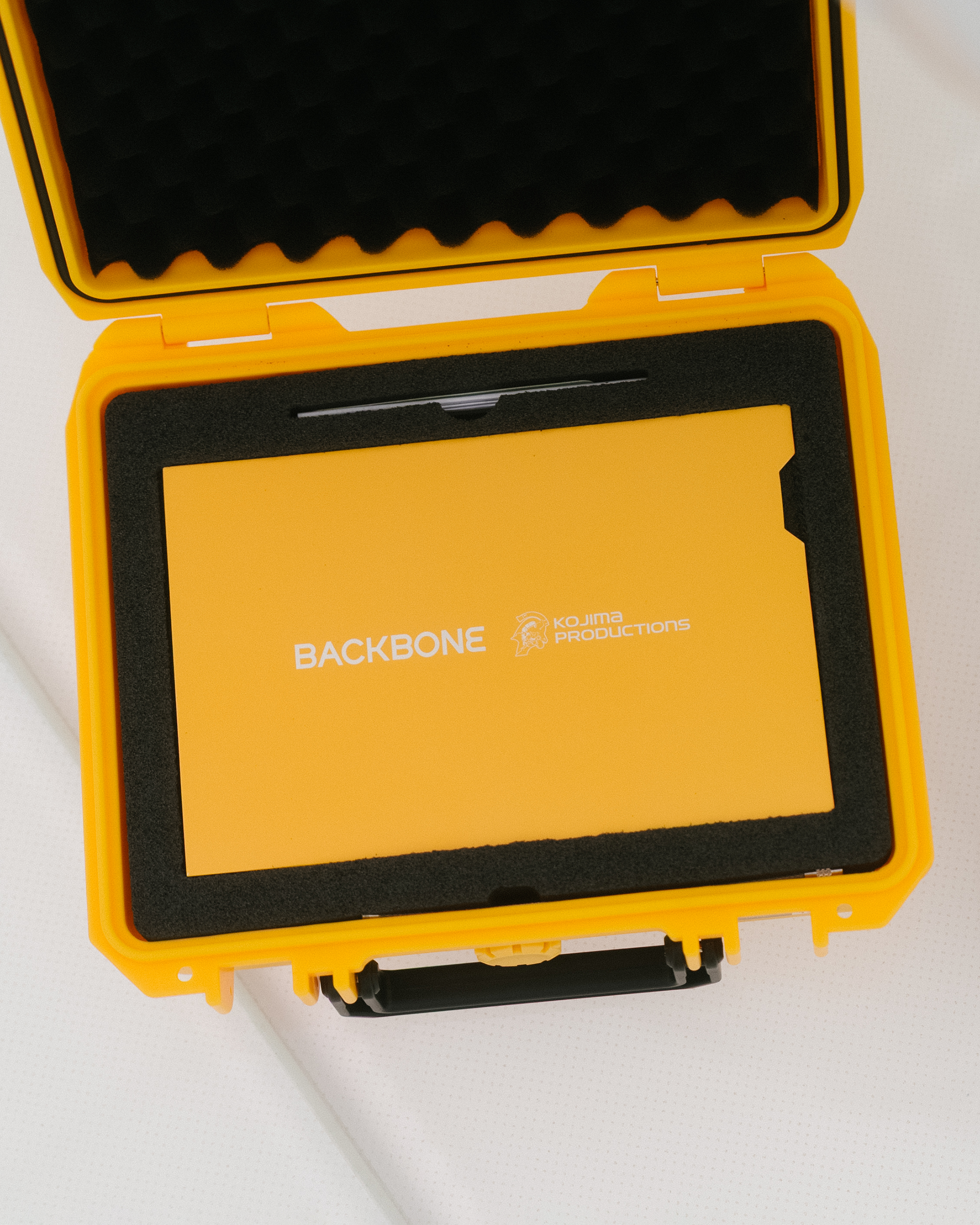 Yellow protective case with 'Backbone' branding on a white background